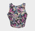 A sleeveless cropped tank top made from stretchy performance knit fabric. The all-over print features a dense, scattered pattern of pastel goth and creepy cute motifs over a light background. Graphics include pink and blue bats in flight, floating eyeballs with blue irises, pink skulls, and glossy vampire lips with sharp white fangs and tongues sticking out. The neckline is a high scoop and the armholes are curved. The fabric comes in either a matte finish or a sparkly silver glitter foil.