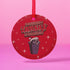 Round red metal Christmas ornament featuring angry possum in Santa hat emerging from trash can. Text reads "Have Yourself a Trashy Little Christmas" in dripping font with stars.