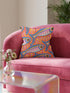 Flat printed square throw pillow cover featuring a faux embroidery texture. The vibrant maximalist design showcases stylized blue, pink, yellow, and white fish swimming in a dynamic, swirling pattern across a bright orange background. The artwork mimics heavy crewelwork yarn and stitching, but the material is a smooth 2D flat print. The pillow is shown as a finished square cover, designed to add bright, colorful eclectic fisherman aesthetic decor to any sofa or seating area.
