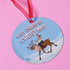 Round blue metal Christmas ornament featuring Glenn Danzig in sunglasses and Christmas lights riding reindeer through snowy landscape. Text reads "Last Caress of Christmas" in icy font.