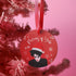 Round red metal Christmas ornament featuring Robert Smith silhouette in black with white Santa hat, red lips, and snowflake details. Text reads "Pictures of Yule" in white script.