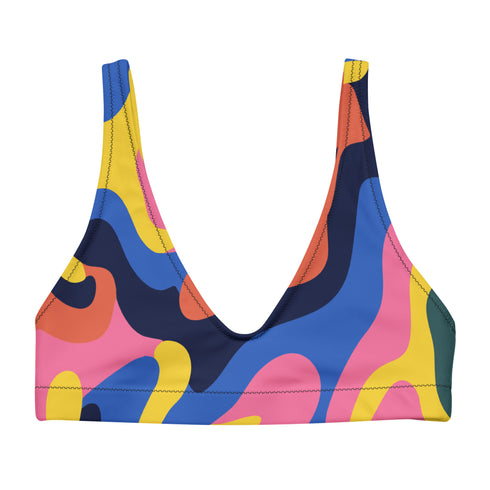Scoop-neck bikini top with wide straps, featuring a bold psychedelic wave print in pink, yellow, blue, orange, and navy. Designed in a sports-bra style silhouette with supportive coverage and a vibrant Y2K vibe. Floating against a turquoise pool background, this top brings festival energy, dopamine brights, and funky retro flair to your swimwear drawer.