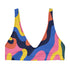 Scoop-neck bikini top with wide straps, featuring a bold psychedelic wave print in pink, yellow, blue, orange, and navy. Designed in a sports-bra style silhouette with supportive coverage and a vibrant Y2K vibe. Floating against a turquoise pool background, this top brings festival energy, dopamine brights, and funky retro flair to your swimwear drawer.
