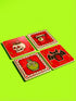 Set of four square glazed ceramic coasters featuring a vibrant pastel goth and creepy cute design. These functional art pieces show a spooky yet playful aesthetic perfect for alternative home decor. The coasters have a glossy wipe-clean finish and a non-slip cork backing to protect furniture surfaces from hot and cold beverages. Ideal for maximalist coffee tables, witchy desks, or as a unique housewarming gift for horror fans who love retro 70s and dopamine decor styles.