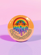 Round orange pinback button featuring bold rainbow psychedelic artwork of a melting third-eye face beneath a rainbow arch. Surrounded by stars and the phrase “Hot, Queer and Radiating” in retro black bubble letters. Glossy metal badge with UV-resistant mylar face and secure safety pin back.