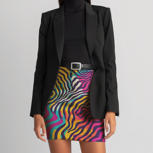 A woman wearing a black blazer and a colorful zebra print skirt.