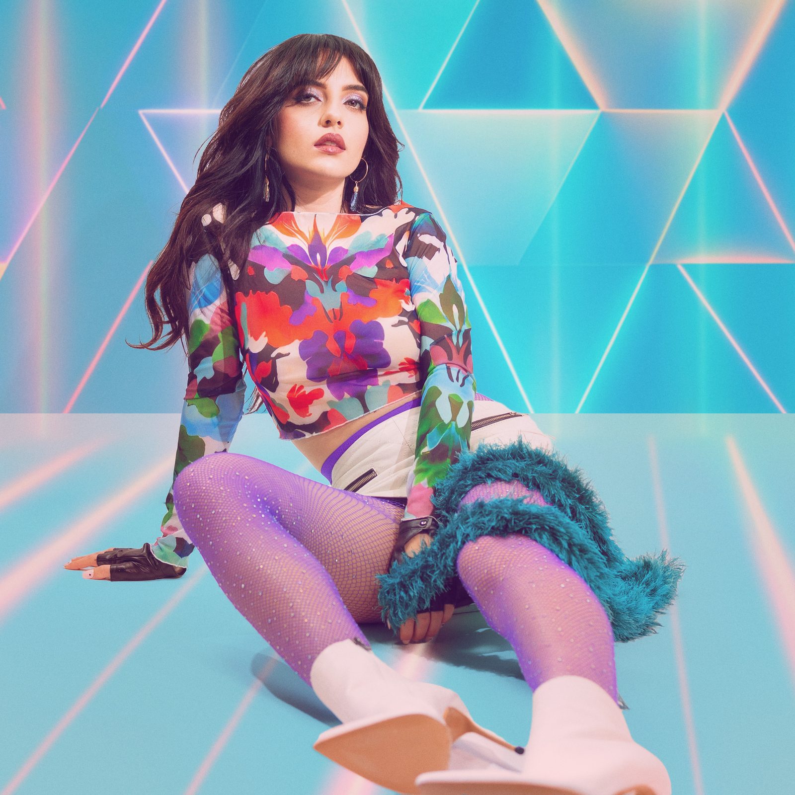 Model in a Honey Dazed maximalist floral mesh top, purple fishnets and white boots