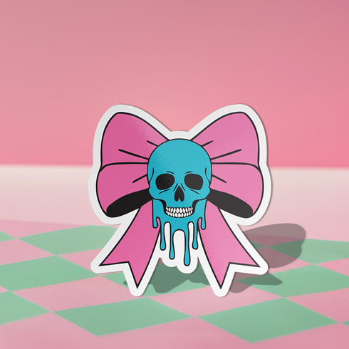 Pastel goth skull bow sticker with a blue skull and pink bow, perfect for creepy cute and punk lovers. Available in Prism, Gem, and Glitter finishes. Handmade in Austin, Texas.