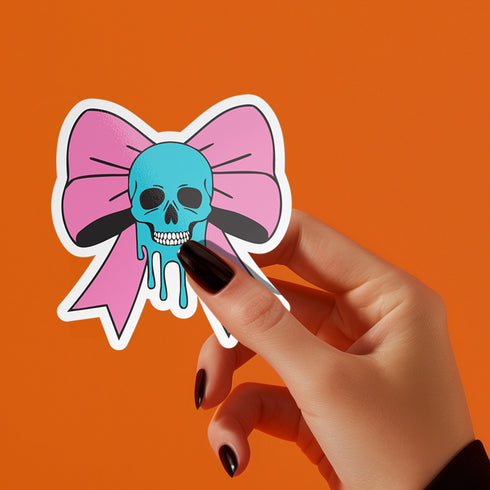 Pastel goth skull bow sticker with a blue skull and pink bow, perfect for creepy cute and punk lovers. Available in Prism, Gem, and Glitter finishes. Handmade in Austin, Texas.