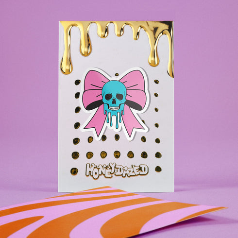 Pastel goth skull bow sticker with a blue skull and pink bow, perfect for creepy cute and punk lovers. Available in Prism, Gem, and Glitter finishes. Handmade in Austin, Texas.