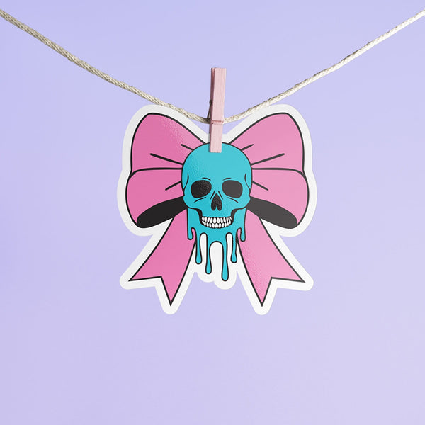 Pastel goth skull bow sticker with a blue skull and pink bow, perfect for creepy cute and punk lovers. Available in Prism, Gem, and Glitter finishes. Handmade in Austin, Texas.