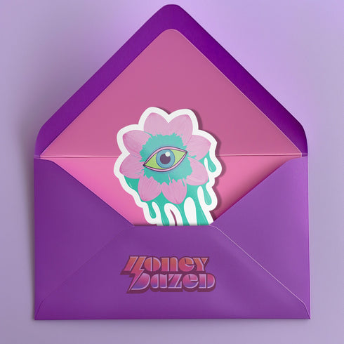 Trippy eyeball flower sticker in pastel pink and green, ideal for quirky and weirdcore enthusiasts. Available in Prism, Gem, and Glitter finishes. Handmade in Austin, Texas.