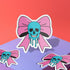 Pastel goth skull bow sticker with a blue skull and pink bow, perfect for creepy cute and punk lovers. Available in Prism, Gem, and Glitter finishes. Handmade in Austin, Texas.