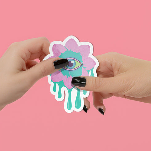 Trippy eyeball flower sticker in pastel pink and green, ideal for quirky and weirdcore enthusiasts. Available in Prism, Gem, and Glitter finishes. Handmade in Austin, Texas.