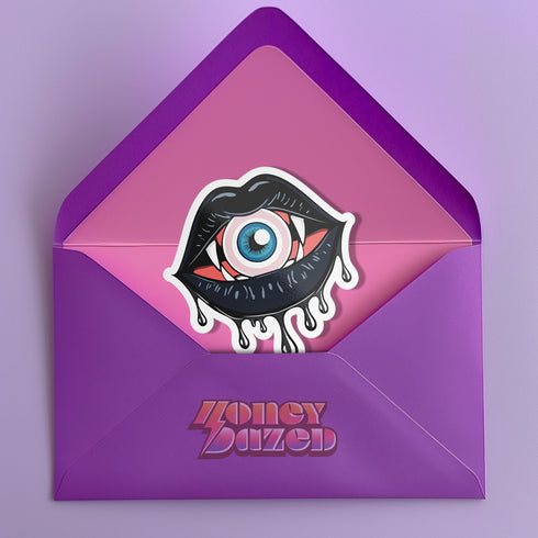 Eyeball vampire fangs sticker with black lips, perfect for adding a spooky touch to laptops, phones, and water bottles. Available in Prism, Gem, and Glitter finishes. Handmade in Austin, Texas.