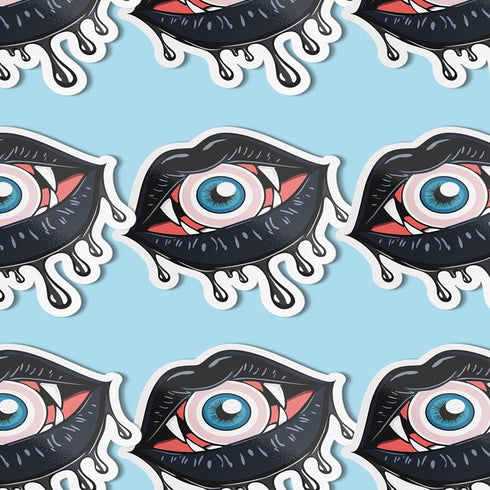 Eyeball vampire fangs sticker with black lips, perfect for adding a spooky touch to laptops, phones, and water bottles. Available in Prism, Gem, and Glitter finishes. Handmade in Austin, Texas.