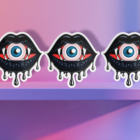 Eyeball vampire fangs sticker with black lips, perfect for adding a spooky touch to laptops, phones, and water bottles. Available in Prism, Gem, and Glitter finishes. Handmade in Austin, Texas.