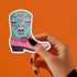 Colorful Goth Cowgirl Boot Sticker with teal and pink boot and skulls, perfect for adding a spooky and quirky touch to your belongings.