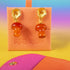 Handmade earrings featuring red agate mushroom-shaped drops with gold-plated caps, suspended from textured gold studs, showcasing unique cottagecore and boho aesthetic.