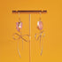 Earrings featuring pink rose quartz stones with 14k gold-plated brass bow designs, offering a sweet and sophisticated touch.
