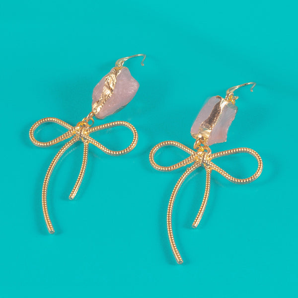 Earrings featuring pink rose quartz stones with 14k gold-plated brass bow designs, offering a sweet and sophisticated touch.