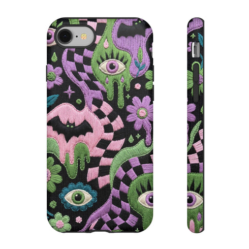 Dual layer phone case in matte or glossy with a 2D print that mimics thick crochet and yarn embroidery. Black bats, pink and green dripping slime, all-seeing eyes with lashes, purple and green daisies, and twisting pink and black checkered worms scatter across a black knit-look background. Smooth printed surface with no raised threads, open ports, and camera cutout. Pastel goth, creepy cute, whimsigoth, spooky maximalist phone accessory and gift.