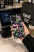 Dual layer phone case in matte or glossy with a 2D print that mimics thick crochet and yarn embroidery. Black bats, pink and green dripping slime, all-seeing eyes with lashes, purple and green daisies, and twisting pink and black checkered worms scatter across a black knit-look background. Smooth printed surface with no raised threads, open ports, and camera cutout. Pastel goth, creepy cute, whimsigoth, spooky maximalist phone accessory and gift.