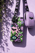 Dual layer phone case in matte or glossy with a 2D print that mimics thick crochet and yarn embroidery. Black bats, pink and green dripping slime, all-seeing eyes with lashes, purple and green daisies, and twisting pink and black checkered worms scatter across a black knit-look background. Smooth printed surface with no raised threads, open ports, and camera cutout. Pastel goth, creepy cute, whimsigoth, spooky maximalist phone accessory and gift.