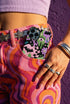 Dual layer phone case in matte or glossy with a 2D print that mimics thick crochet and yarn embroidery. Black bats, pink and green dripping slime, all-seeing eyes with lashes, purple and green daisies, and twisting pink and black checkered worms scatter across a black knit-look background. Smooth printed surface with no raised threads, open ports, and camera cutout. Pastel goth, creepy cute, whimsigoth, spooky maximalist phone accessory and gift.