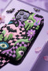 Dual layer phone case in matte or glossy with a 2D print that mimics thick crochet and yarn embroidery. Black bats, pink and green dripping slime, all-seeing eyes with lashes, purple and green daisies, and twisting pink and black checkered worms scatter across a black knit-look background. Smooth printed surface with no raised threads, open ports, and camera cutout. Pastel goth, creepy cute, whimsigoth, spooky maximalist phone accessory and gift.