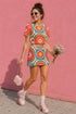 Short sleeve crew neck t-shirt dress in a relaxed, oversized straight cut, made of 100% polyester with a soft matte finish. An edge-to-edge all-over print on a cream background shows 60s daisies in red, yellow, and white set inside concentric rings of lime green, hot pink, orange, and royal blue, with magenta squares and red checkerboard accents. Retro 60s mod, flower power, rainbow maximalist alt fashion.