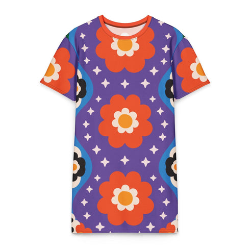 Short sleeve crew neck t-shirt dress in a relaxed, oversized straight cut, made of 100% polyester with a soft matte finish. An edge-to-edge all-over print on a medium purple background shows vertically stacked daisies with orange petals and yellow centers, scattered white four-point stars, and blue and green wavy side borders filled with small black and white daisies. Retro 70s floral, groovy maximalist alt fashion.