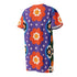Short sleeve crew neck t-shirt dress in a relaxed, oversized straight cut, made of 100% polyester with a soft matte finish. An edge-to-edge all-over print on a medium purple background shows vertically stacked daisies with orange petals and yellow centers, scattered white four-point stars, and blue and green wavy side borders filled with small black and white daisies. Retro 70s floral, groovy maximalist alt fashion.