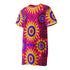 Short sleeve crew neck t-shirt dress in a relaxed, oversized straight cut, made of 100% polyester with a soft matte finish. An edge-to-edge all-over print shows yellow radial sunburst medallions with jagged rays on a hot pink background, layered blue and pink circular centers, rows of small blue stars, a partial eye near the top, and dark charcoal swirling vine filigree along the hem. Psychedelic 70s retro, celestial, whimsigoth maximalist alt fashion.