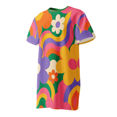 Short sleeve crew neck t-shirt dress in a relaxed, oversized straight cut, made of 100% polyester with a soft matte finish. An edge-to-edge all-over print shows pop-art daisies in cream, yellow, orange, and purple layered over wavy psychedelic stripes of hot pink, kelly green, orange, purple, and yellow. Retro 60s mod, flower power, psychedelic pop art, dopamine dressing maximalist alt fashion for festivals.
