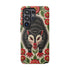 Dual layer matte phone case with a 2D print that mimics thick crewel embroidery. An angry black possum with a white face, bared sharp teeth, and bright red eyes and claws sits at the center on a cream background, framed by a symmetrical border of red folk art daisies with yellow centers and green leaves. Smooth printed surface with no raised threads, open ports, and a precise camera cutout. Goblincore, creepy cute, maximalist phone accessory.