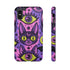 Dual layer matte phone case with a 2D print that mimics raised embroidery. Dark purple vampire bat cat heads with tall pointed ears, glowing chartreuse eyes, tiny fangs, and a pink crescent moon on the forehead repeat across a mottled purple and hot pink background, scattered with large chartreuse evil eyes with purple irises and small dark stars. Smooth printed surface with no raised threads, open ports, and camera cutout. Pastel goth, whimsigoth, creepy cute phone accessory.