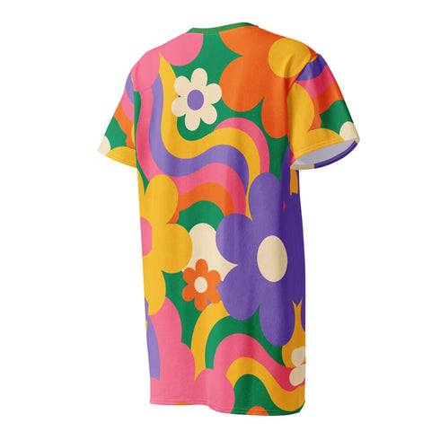 Short sleeve crew neck t-shirt dress in a relaxed, oversized straight cut, made of 100% polyester with a soft matte finish. An edge-to-edge all-over print shows pop-art daisies in cream, yellow, orange, and purple layered over wavy psychedelic stripes of hot pink, kelly green, orange, purple, and yellow. Retro 60s mod, flower power, psychedelic pop art, dopamine dressing maximalist alt fashion for festivals.
