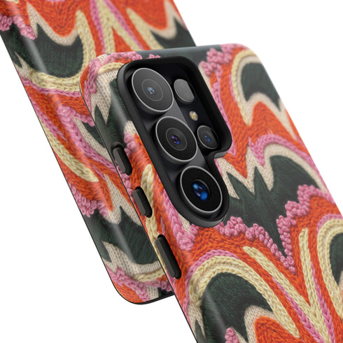 Dual layer matte phone case with a 2D print that mimics thick, heavy crochet yarn. Rows of stacked black bats repeat across a vibrant rust-orange background, accented with bright pink faux yarn bobbles and framed by cream arched lines. Smooth printed surface with no raised threads, open ports, and a precise camera cutout. Pastel goth, creepy cute, Summerween and Halloween phone accessory with a cozy handmade look.