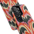 Dual layer matte phone case with a 2D print that mimics thick, heavy crochet yarn. Rows of stacked black bats repeat across a vibrant rust-orange background, accented with bright pink faux yarn bobbles and framed by cream arched lines. Smooth printed surface with no raised threads, open ports, and a precise camera cutout. Pastel goth, creepy cute, Summerween and Halloween phone accessory with a cozy handmade look.