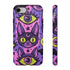 Dual layer matte phone case with a 2D print that mimics raised embroidery. Dark purple vampire bat cat heads with tall pointed ears, glowing chartreuse eyes, tiny fangs, and a pink crescent moon on the forehead repeat across a mottled purple and hot pink background, scattered with large chartreuse evil eyes with purple irises and small dark stars. Smooth printed surface with no raised threads, open ports, and camera cutout. Pastel goth, whimsigoth, creepy cute phone accessory.