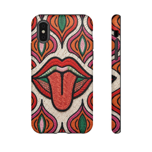 Dual layer matte phone case with a 2D print that mimics heavy crochet and thick knit yarn. A large open mouth with bright red lips and a red tongue sticking out sits at the center of a cream background, surrounded by mirrored teardrop and flame shapes in bright orange, dark green, and hot pink with black stitch-style outlines. Smooth printed surface with no raised threads, open ports, and camera cutout. Psychedelic 70s pop art phone accessory.