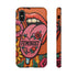 Dual layer matte phone case with a 2D print that mimics knit and embroidery texture. A retro open mouth with its tongue out sits over a pink heart stitched with the word FEMINIST in black letters, on an orange knit-look background filled with pink flowers, yellow sunflowers, red roses, purple and orange blooms, teal leaves, and a turquoise drip, all outlined in bold black. Smooth printed surface, open ports, camera cutout. Feminist maximalist phone accessory.