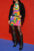 Short sleeve crew neck t-shirt dress in a relaxed, oversized straight cut, made of 100% polyester with a soft matte finish. An edge-to-edge all-over print shows pop-art daisies in cream, yellow, orange, and purple layered over wavy psychedelic stripes of hot pink, kelly green, orange, purple, and yellow. Retro 60s mod, flower power, psychedelic pop art, dopamine dressing maximalist alt fashion for festivals.
