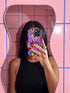 Dual layer matte phone case with a 2D print that mimics raised embroidery. Dark purple vampire bat cat heads with tall pointed ears, glowing chartreuse eyes, tiny fangs, and a pink crescent moon on the forehead repeat across a mottled purple and hot pink background, scattered with large chartreuse evil eyes with purple irises and small dark stars. Smooth printed surface with no raised threads, open ports, and camera cutout. Pastel goth, whimsigoth, creepy cute phone accessory.