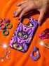 Dual layer matte phone case with a 2D print that mimics raised embroidery. Dark purple vampire bat cat heads with tall pointed ears, glowing chartreuse eyes, tiny fangs, and a pink crescent moon on the forehead repeat across a mottled purple and hot pink background, scattered with large chartreuse evil eyes with purple irises and small dark stars. Smooth printed surface with no raised threads, open ports, and camera cutout. Pastel goth, whimsigoth, creepy cute phone accessory.