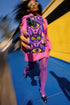 Dual layer matte phone case with a 2D print that mimics raised embroidery. Dark purple vampire bat cat heads with tall pointed ears, glowing chartreuse eyes, tiny fangs, and a pink crescent moon on the forehead repeat across a mottled purple and hot pink background, scattered with large chartreuse evil eyes with purple irises and small dark stars. Smooth printed surface with no raised threads, open ports, and camera cutout. Pastel goth, whimsigoth, creepy cute phone accessory.