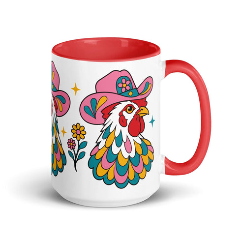 Glossy white ceramic coffee mug with a colored rim, inside, and handle and a full wraparound folk art print. Chickens wear pink cowboy hats with teal bands, yellow diamonds, flowers, and teardrop motifs. The birds have white heads, red combs and wattles, and layered pink, teal, and golden yellow feathers outlined in black. Pink and yellow flowers, teal leaves, and four-point starbursts fill the space between. Retro western kitchen decor.