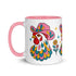 Glossy white ceramic coffee mug with a colored rim, inside, and handle and a full wraparound folk art print. Chickens wear pink cowboy hats with teal bands, yellow diamonds, flowers, and teardrop motifs. The birds have white heads, red combs and wattles, and layered pink, teal, and golden yellow feathers outlined in black. Pink and yellow flowers, teal leaves, and four-point starbursts fill the space between. Retro western kitchen decor.