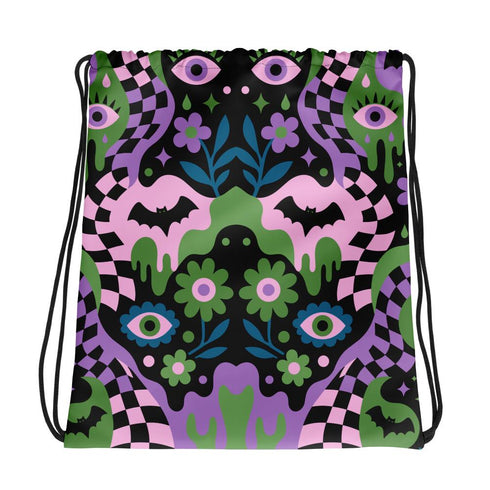 Drawstring backpack measuring 15 by 17 inches, made of 100% polyester with narrow shoulder straps and a drawstring closure. A symmetrical pastel goth print of bats, stylized eyes, flowers, and stars in a soft pastel palette sits on a black base, framed by purple and green checkerboard bands. Creepy cute, whimsigoth, kawaii goth style bag made for the gym, concerts, festivals, travel, school, and everyday carry.